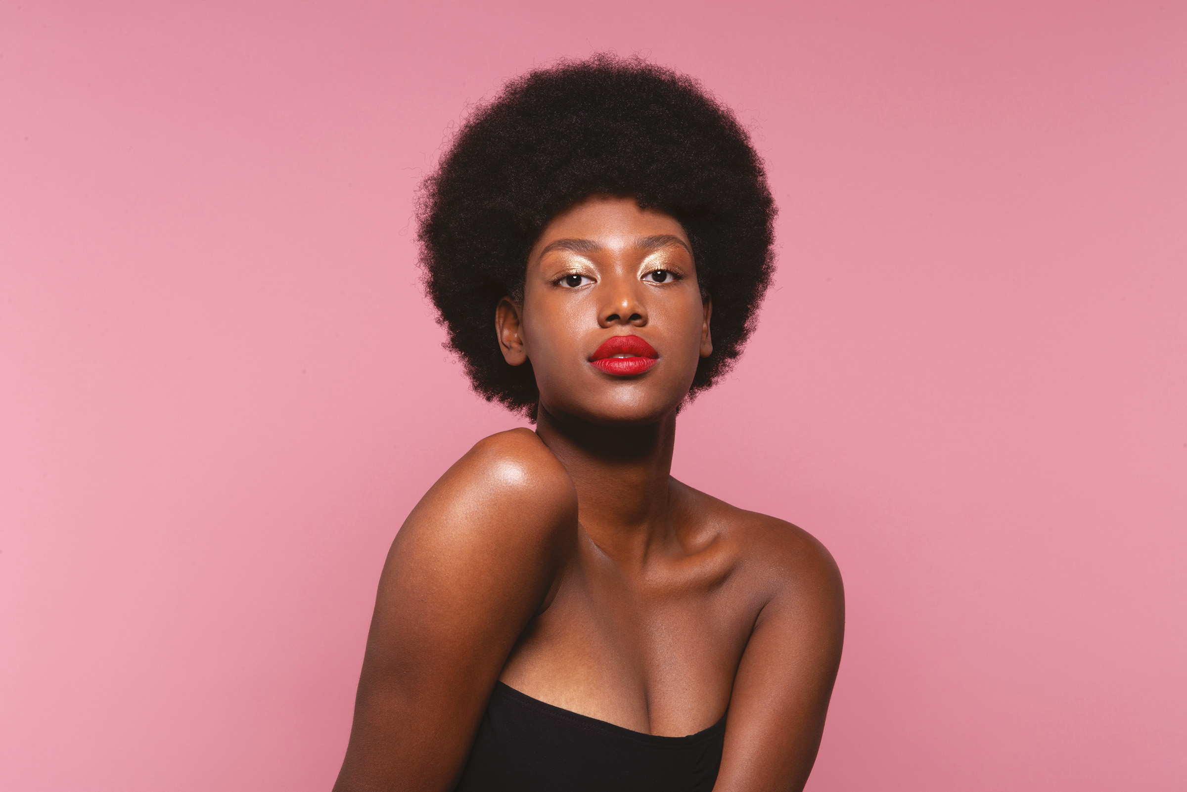 Woman with red lipstick on a pink background